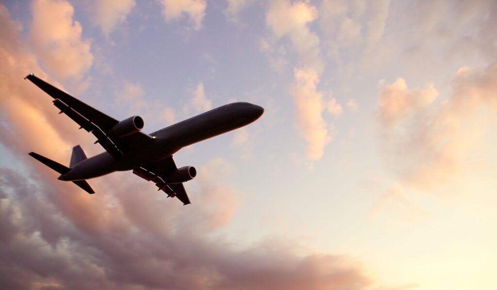 Plane from underneath in front of clouds