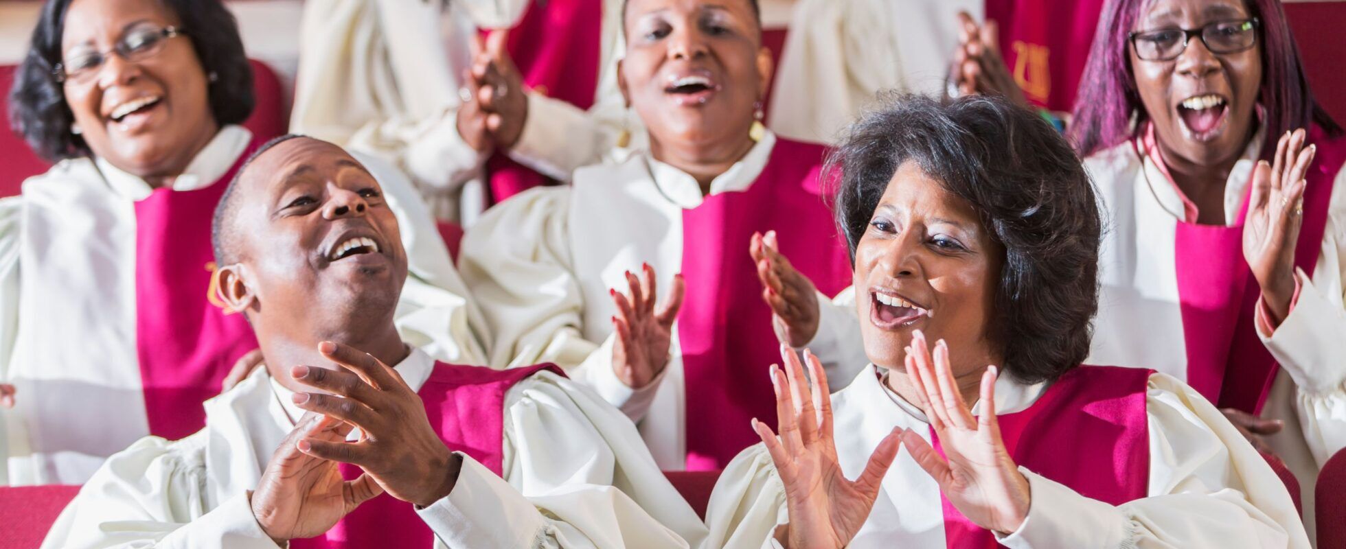 Men and women in robes singing in a gospel choir