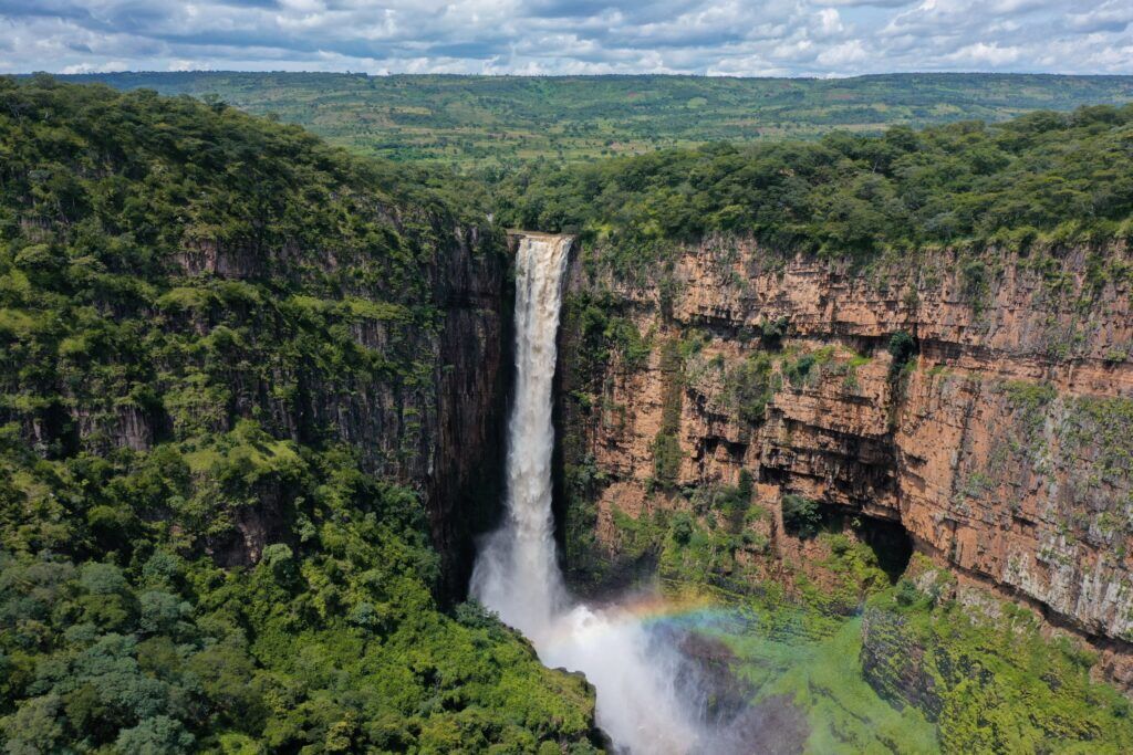 Kalambo waterfalls surrounded by green landscape and cliffs