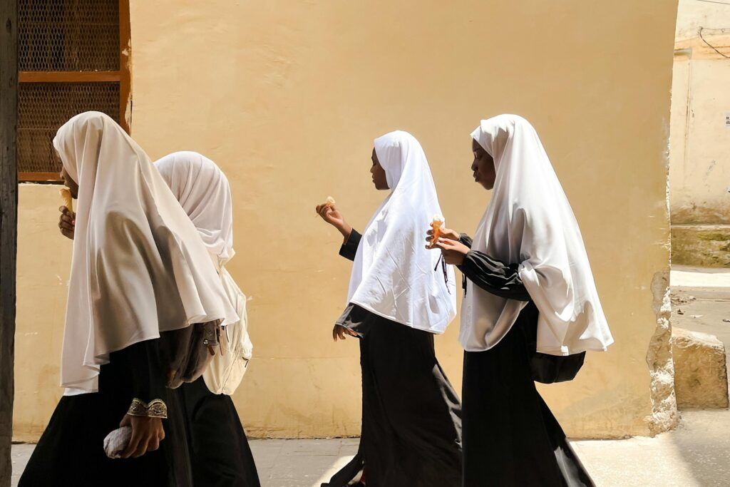 Four young girls dressed in traditional muslim clothing