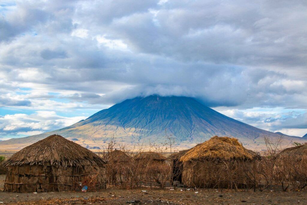 Ol doinyo lengai mountain in Tanzania with huts in the front