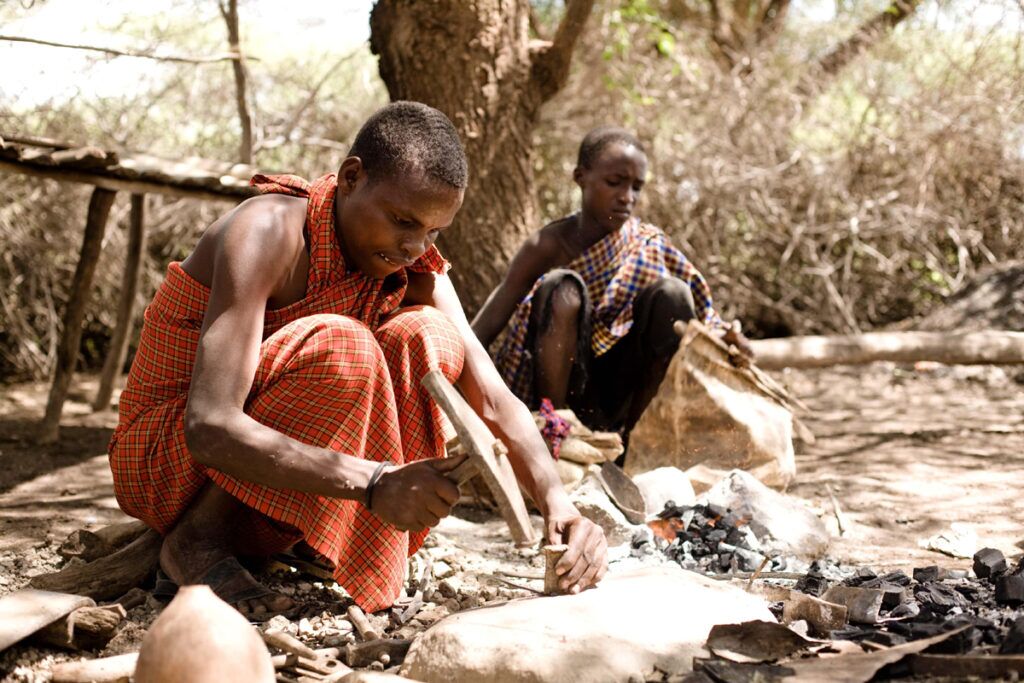 Two men of iraqw tribe with traditional tools