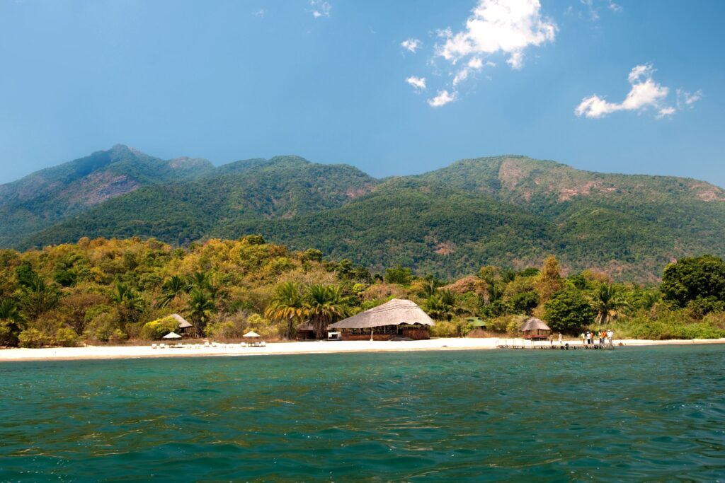 Lake Tanganyika with mountains and a hut in the background