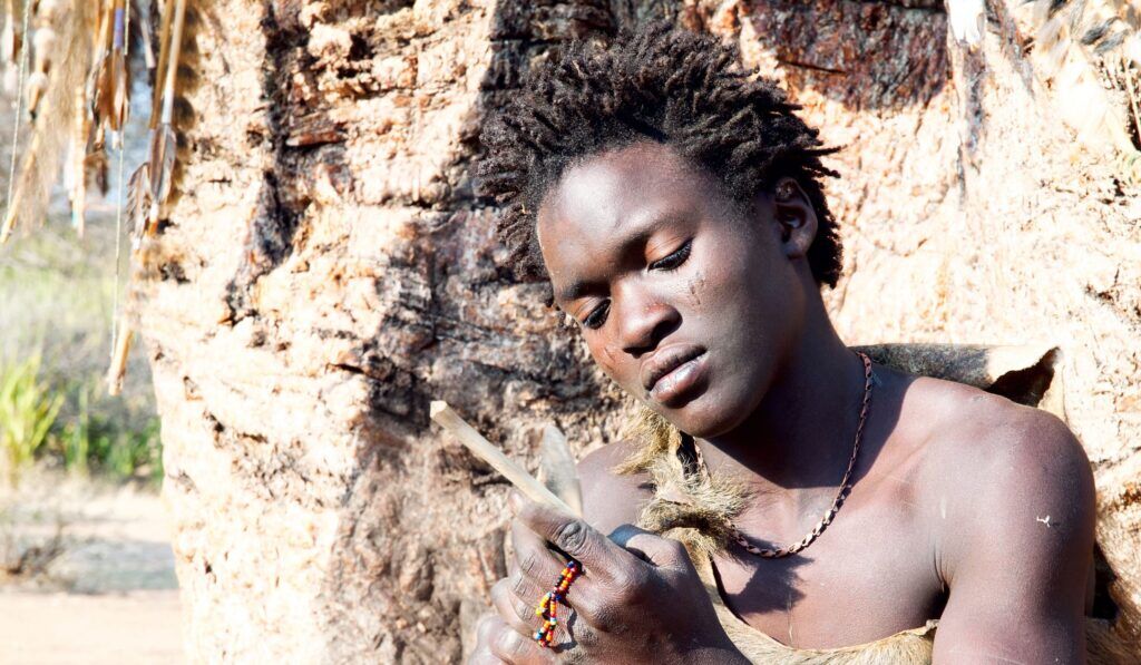 Young member of Hadzabe tribe carving wood