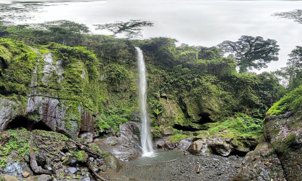 Mount Meru waterfall with high cliffs and trees