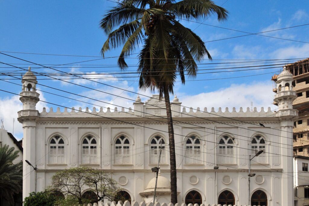 Mosque in Dar es Salaam, Tanzania, with a palm tree in front of it