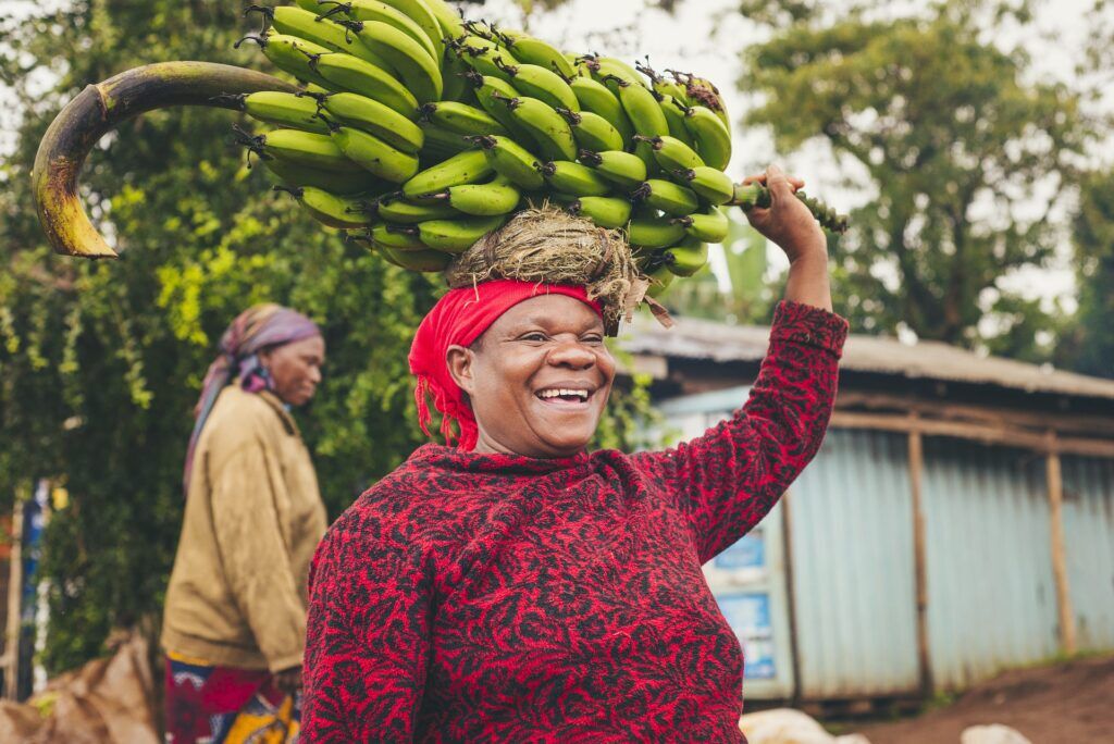 Woman in Tanzania carrying bananas on her head